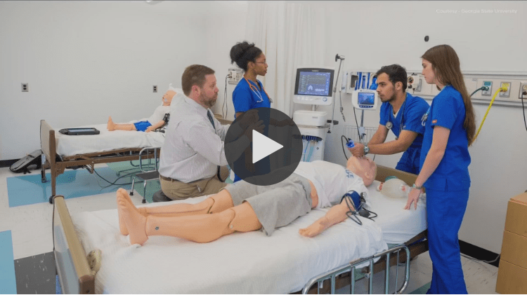 People in class working on mannequin