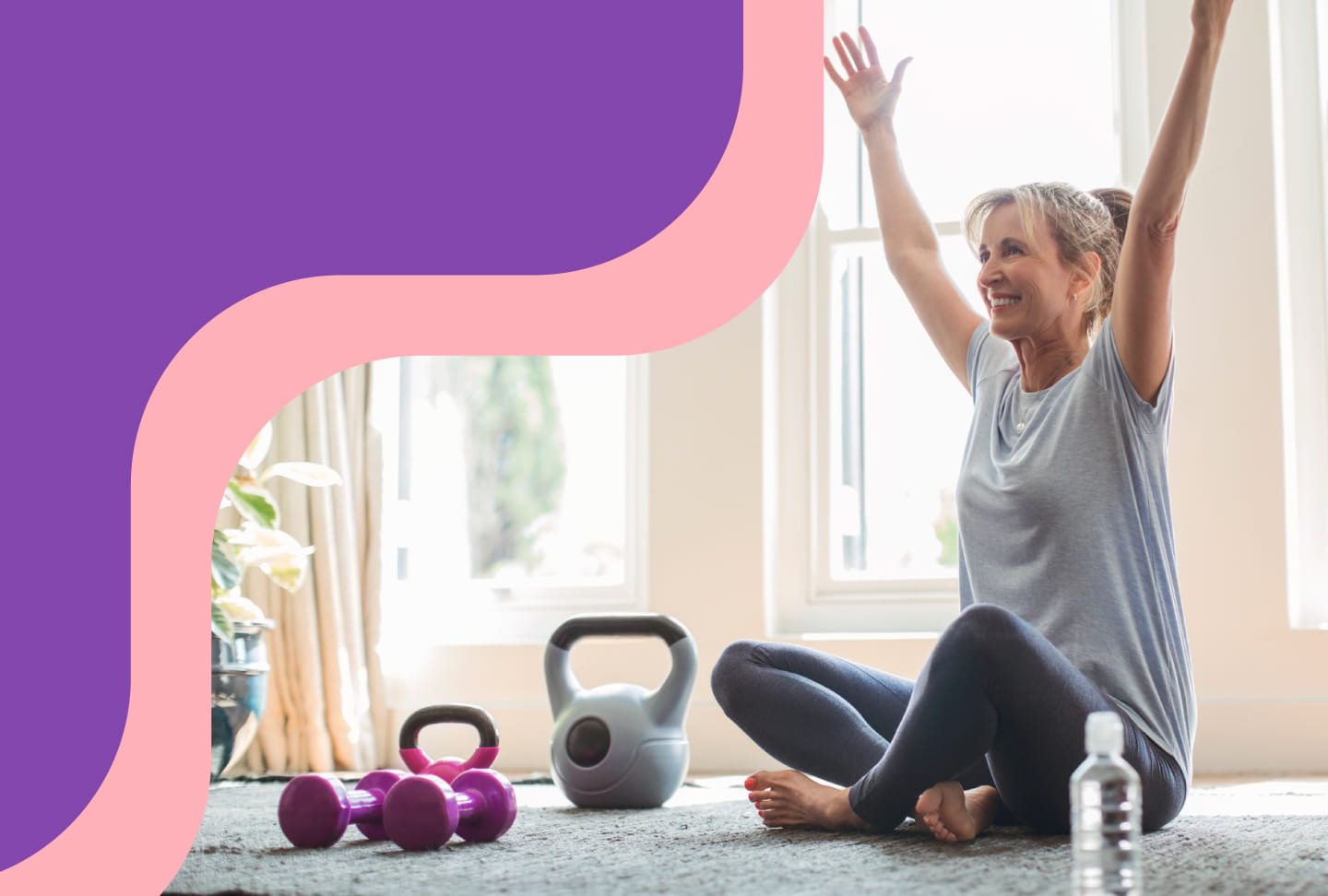 Woman stretching on the floor with a set of dumbbells and hand weights.