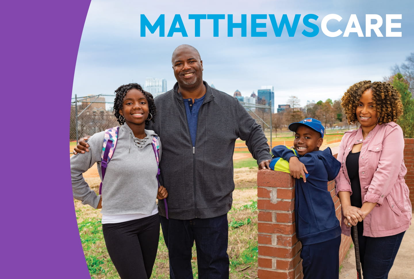 The Matthews family smiling in the park