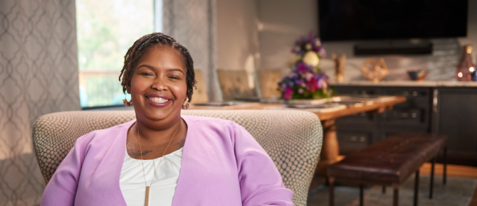 Latoya Jordan sitting in her home